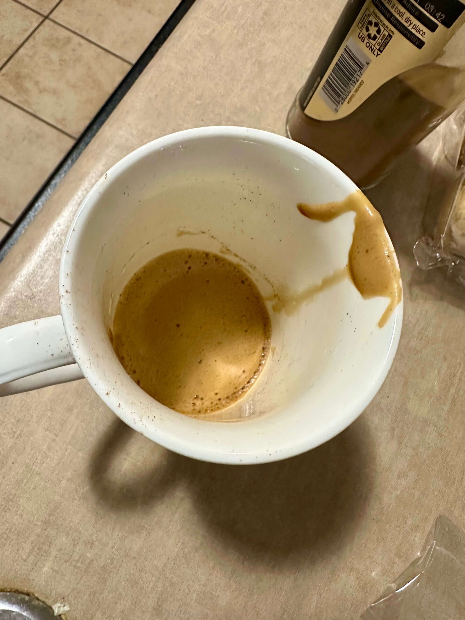 frothy base for nescafe latte Frothy foamy base of espresso grounds and hot water in a white coffee cup